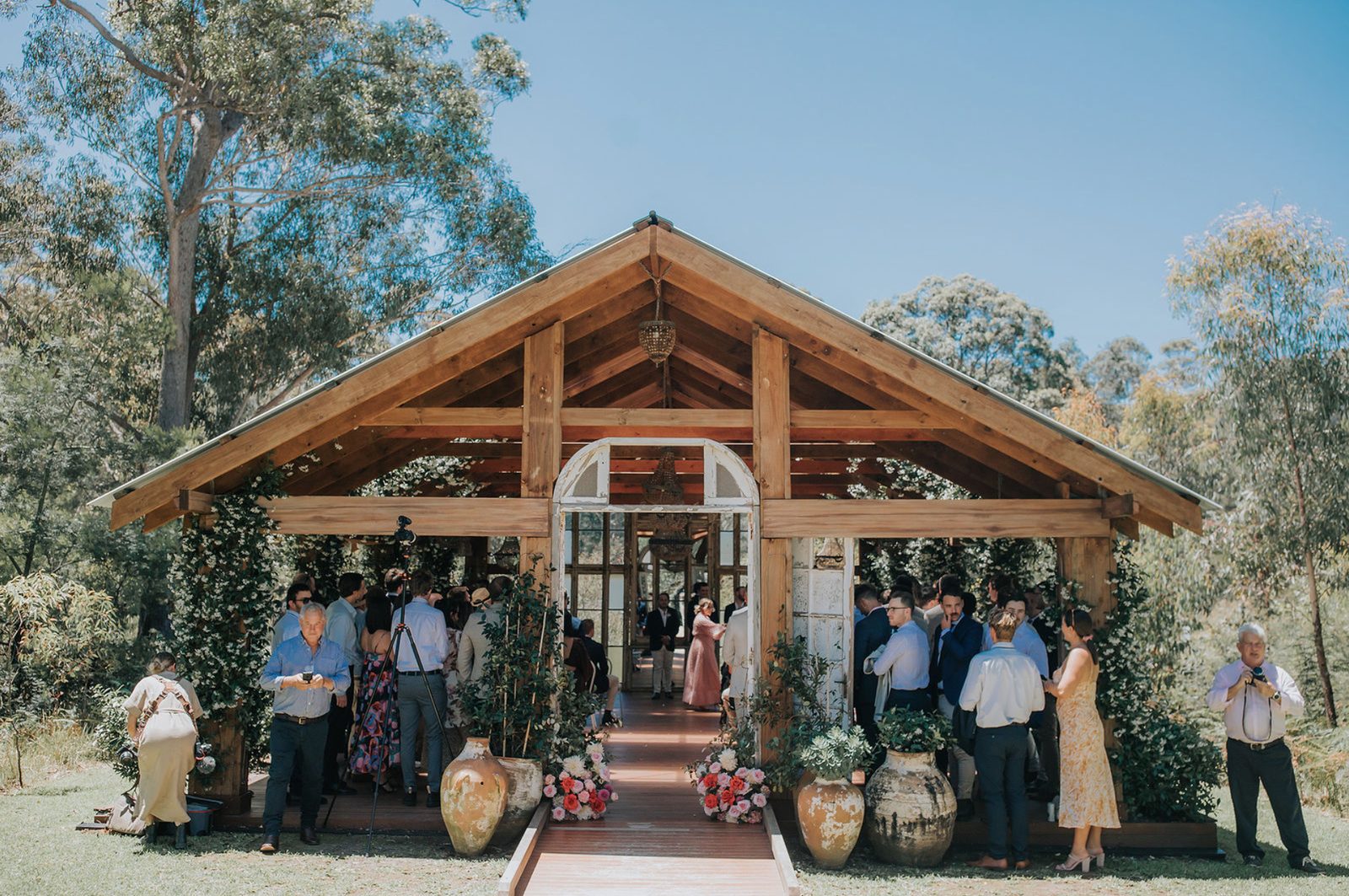 The open-sided timber Bush Chapel with guests gathered at its doors