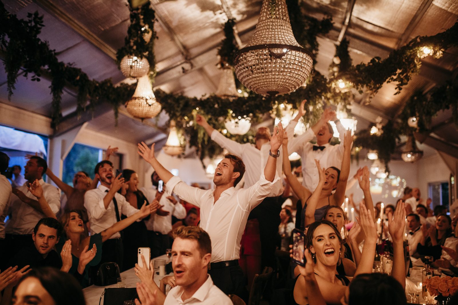A packed dance floor in the Wedding Shed, arms in the air